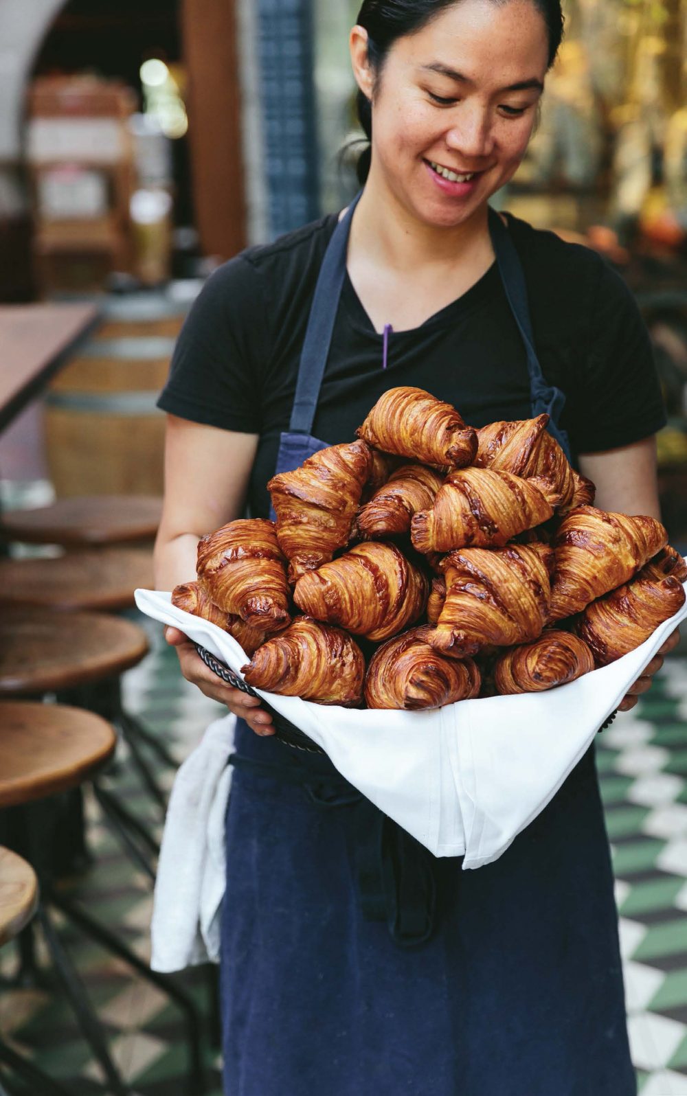 chef margarita holding a tray full of croissants